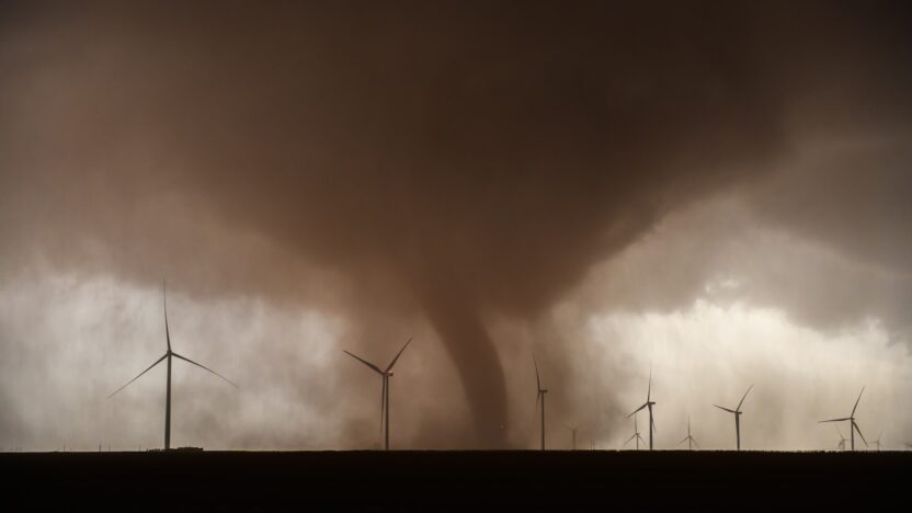 a large tornado is coming out of a field